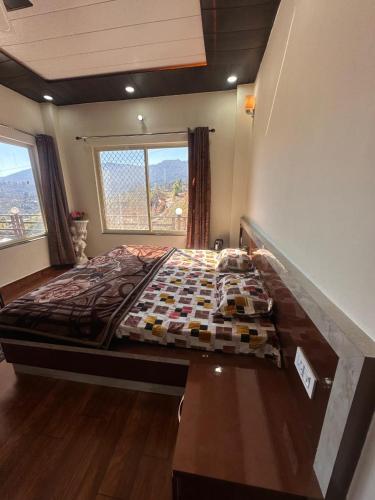 a bedroom with a large bed in a room at Mountview guest house in Mukteshwar