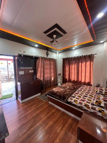 a bedroom with a large bed and wooden floors at Mountview guest house in Mukteshwar
