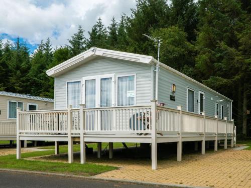 a mobile home with a porch and a deck at Flamingo's Rest - Uk3348 in Newton on the Moor