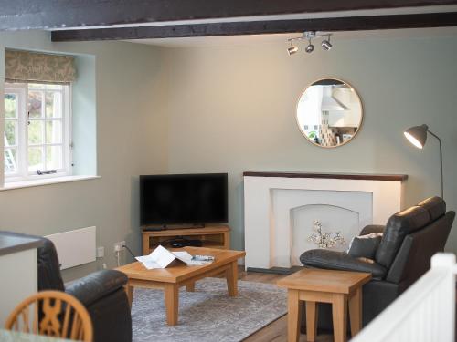a living room with a couch and a television at Number Eight - Ukc4971 in Tawstock