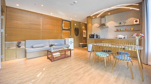 a living room with a couch and a table and chairs at Gapyeong Laputa Resort in Gapyeong