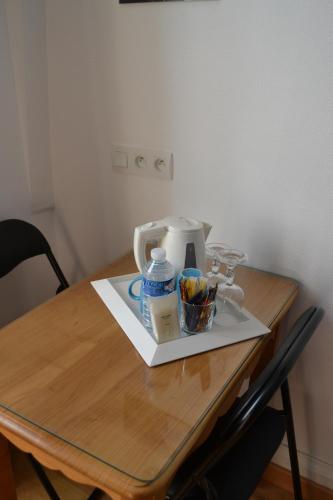a table with a coffee maker on top of it at Hôtel La Porte Saint Pierre-Logis Hôtel Intra Muros in Saint Malo