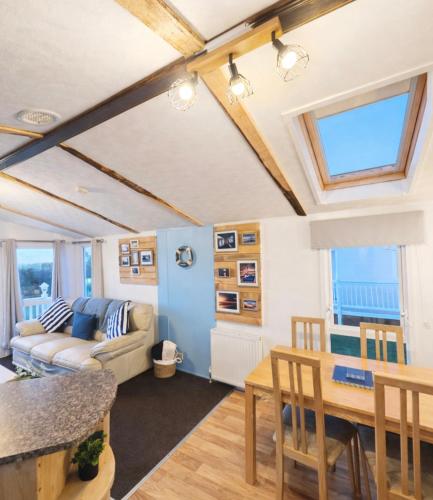 a living room with a couch and a table at Riverscape Northumberland in Ashington