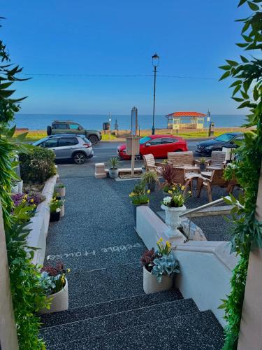 a parking lot with a bunch of potted plants at Pebble House in Llandudno