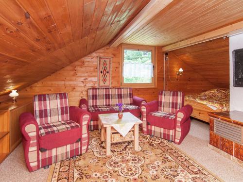 Kurort Steinbach-HallenbergにあるHoliday home near the ski areaのリビングルーム(椅子、テーブル、ベッド付)