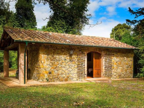 a small stone building with a wooden door at Belvilla by OYO Holiday Home with Pool in Canneto