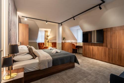 a bedroom with a bed and a flat screen tv at Dolce Vita Hotel Art in Budapest