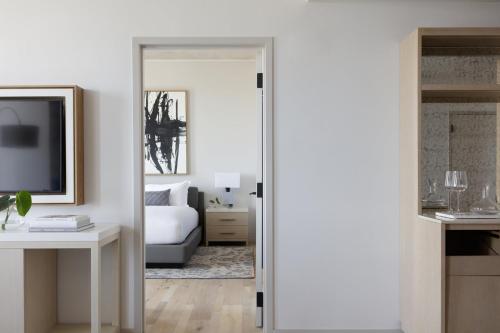 a bedroom with a door leading into a living room at Kimpton - Pittman Hotel by IHG in Dallas