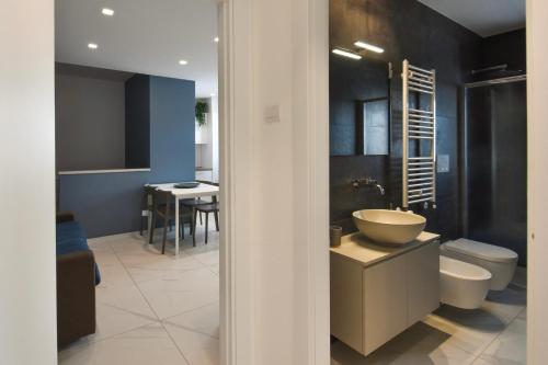 a bathroom with a sink and a toilet at LifeStyle Boutique Apartment in Monopoli