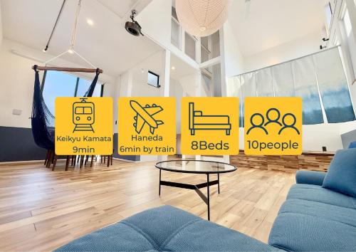 a living room with yellow signs on the wall at UKIYO BLUE-羽田空港6分-品川駅7分-最大10名貸切一軒家-100inchスクリーン完備 in Tokyo