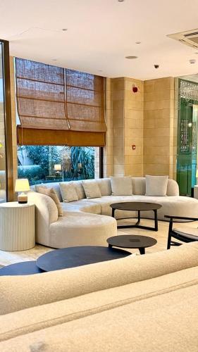 a large living room with couches and tables in it at Centrum Hotel - City Center in Nicosia