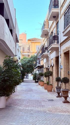an empty street with potted plants and buildings at Centrum Hotel - City Center in Nicosia
