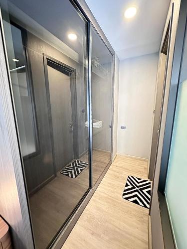 a walk in shower with a glass door at Muay Thai Apartment - Ratchada in Bangkok