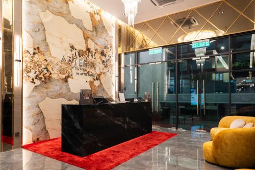 a lobby with a red carpet and a large wall at Asteria Melaka by Attic Suite in Malacca
