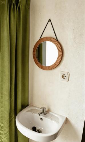 a bathroom with a sink and a mirror at Bale Cakra in Ngemplak