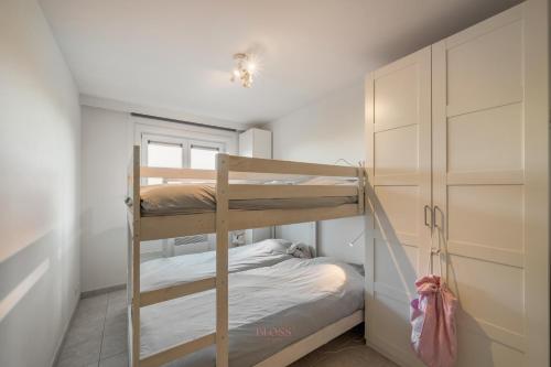 a bedroom with two bunk beds and a closet at Port Albert by BLOSS in Nieuwpoort