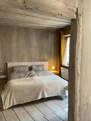 a bedroom with a large bed with a wooden floor at Ferienwohnung "Atelier_1" in Edenkoben