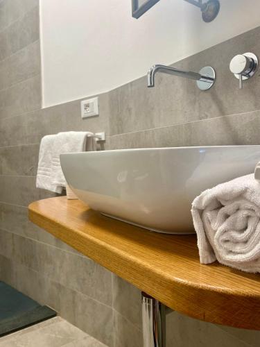 a white sink on a wooden counter in a bathroom at EvasRooms Open space in Vernazza