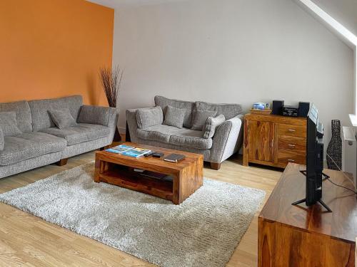 a living room with two couches and a television at Moat House 6 - Ukc4889 in Fort Augustus