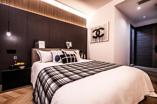 a bedroom with a large bed with a black wall at Shanghai Hills&Rais Apartment - 100-inch Projector - Near Nanjing Road Pedestrian Street in Shanghai