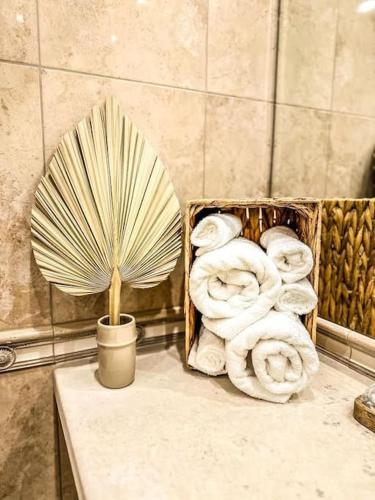 a box of towels on a table with a plant at Seaside Sunset - free parking in Golden Sands