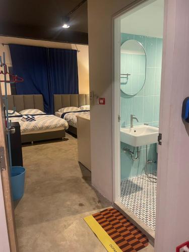 a room with a bathroom with a sink and a mirror at MAXi MaMa Room in Bangkok