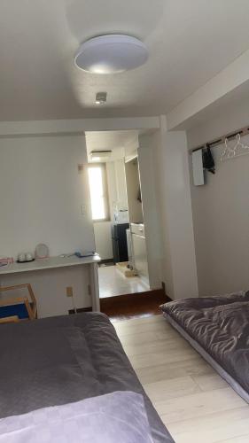 a room with a bed and a kitchen in it at Kinjiro Hotel in Tokyo