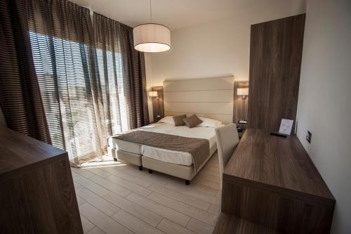 Postel nebo postele na pokoji v ubytování Hotel Pineta Mare