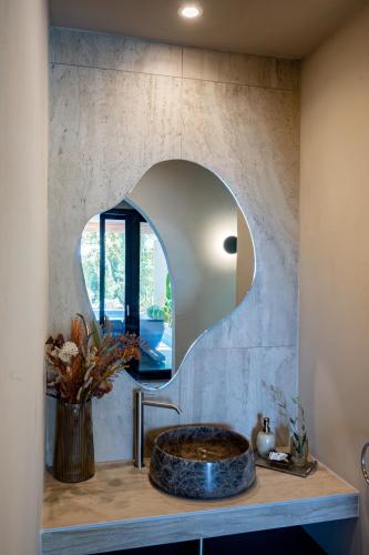 a bathroom with a sink and a mirror at Euphoria Villa, 9 bdrs with private pools, beachfront in Kalogria