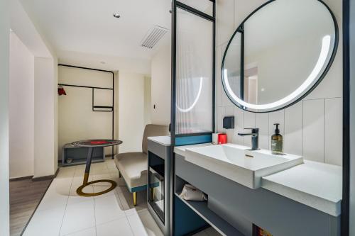 a bathroom with a sink and a mirror at Ibis Beijing Tiananmen Square in Beijing