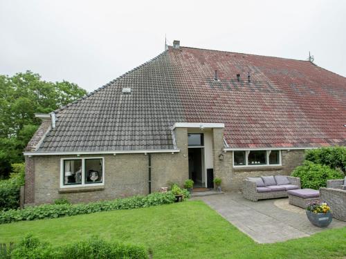 a brick house with a couch in the yard at Modern Farmhouse in Molkwerum near the Lake in Molkwerum