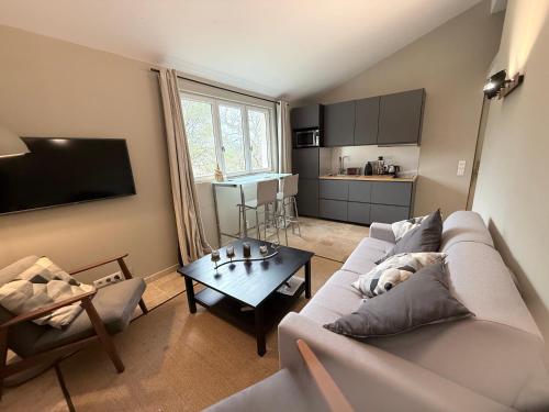 un soggiorno con un divano e un tavolo di Guest House a Montauroux