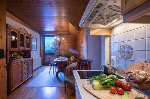 a kitchen with a counter with vegetables on a cutting board at Aparthotel Gallahaus in Zell am Ziller