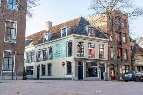 a white building with a stop sign in front of it at Bakery Boutique Hotel in Leeuwarden