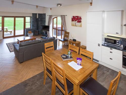 a kitchen and living room with a table and a couch at Laurel Cottage - Ukc6256 in Linlithgow