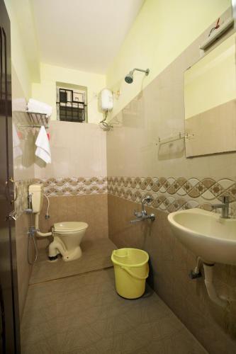 a bathroom with a sink and a toilet at Hotel I Live Inn in Chennai
