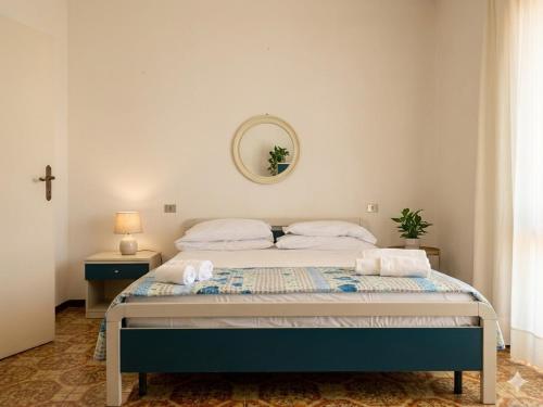 a bedroom with a bed with a cross on the wall at VILLETTA 8 - Premium Villas in Giulianova