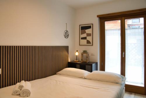a bedroom with a bed with towels on it at NNHouse: large terrace and marvelous view in Cassina Valsassina