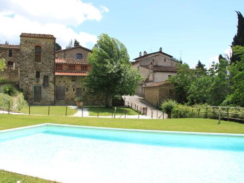 a large swimming pool in front of a building at Belvilla by OYO Le Olive in Vaglia