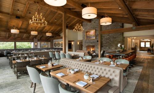 a restaurant with wooden ceilings and tables and chairs at The Ranch at Laguna Beach in Laguna Beach