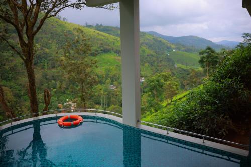 a swimming pool with a view of a mountain at La Paraiso by WhiteTrip in Vagamon