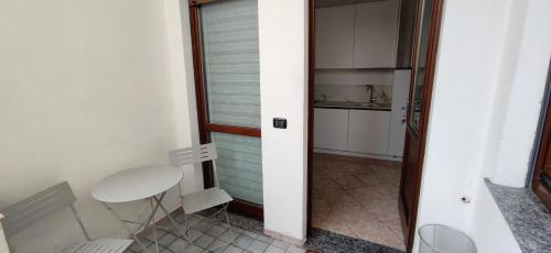 a small room with a white table and a mirror at SISTERS GUEST HOUSE 2 in Somma Lombardo