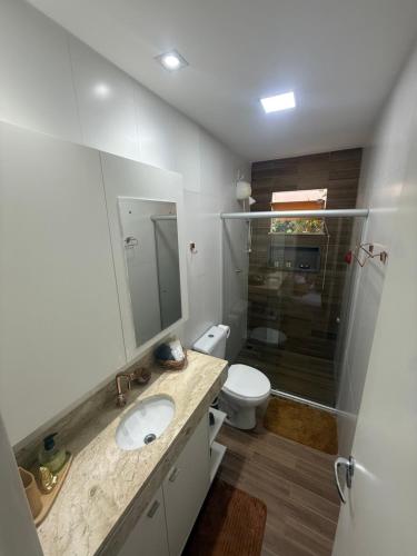 a bathroom with a sink and a toilet and a shower at Casa 2 quarto em condomínio in Camaçari