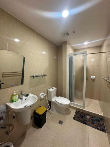 a bathroom with a toilet and a sink and a shower at Your Quiet Home with Unbeatable location in Baguio