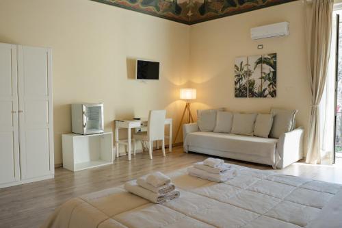 a living room with a bed and a couch at B&B Matteo Bonello - Fianco Cattedrale in Palermo