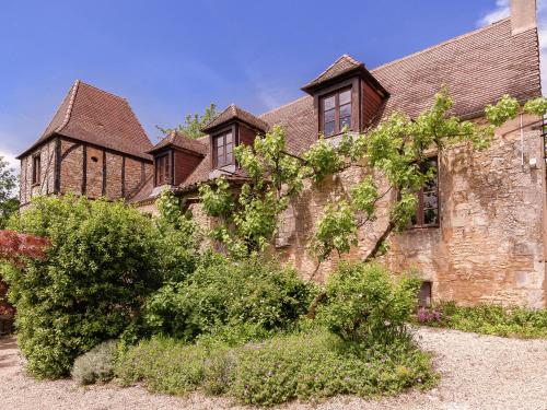 an old stone building with a church at Holiday home in Aquitaine with private garden in Meyrals