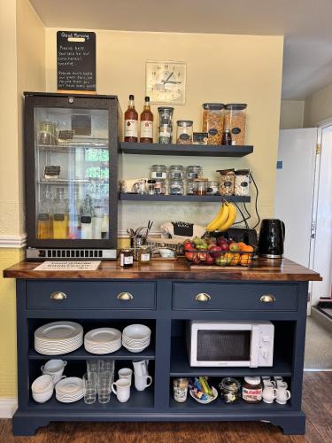 a kitchen with a counter with a microwave at The Coach House in Melbourne