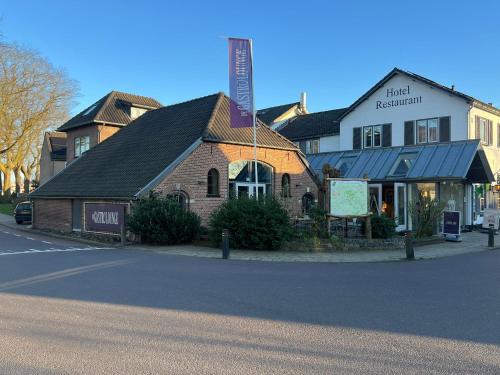 a building on the side of a street with a street at De Gastrolounge in Vorden