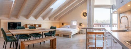 a kitchen and living room with a table and a bed at Ferienwohnungen Gut Mischenried in Weßling