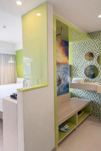 a room with a bed and a kitchen with a counter at Ion Bali Benoa in Nusa Dua